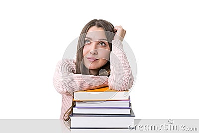 Dreamy student with a pile of books Stock Photo