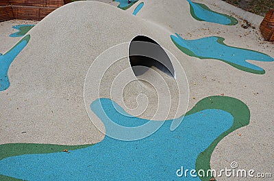 Dreamy white rubber landscape with scoops and colorful spots on the playground. stainless steel tunnel through the wave. design co Stock Photo