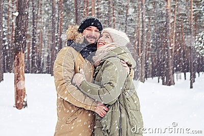 Dreamy woman looking at the sky in the embrace of husband under Stock Photo