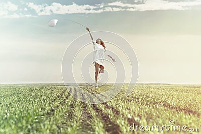 Dreamy woman runs happy in the middle of nature Stock Photo