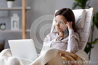 Dreamy woman writer sitting in chair thinking of new idea Stock Photo