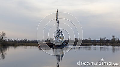 Dredger is working to deepen the fairway on the river. Cleaning and deepening by a dredger on the river. Stock Photo