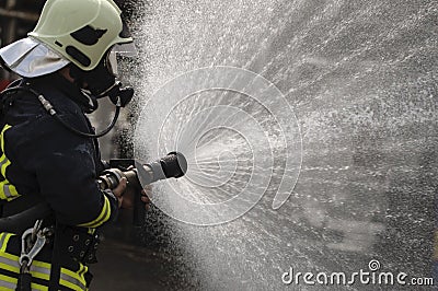 Drenched Firefighter Stock Photo