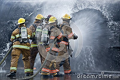 Drenched Firefighters Stock Photo