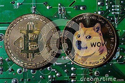 A Dogecoin and a Bitcoin on a green circuit board Editorial Stock Photo