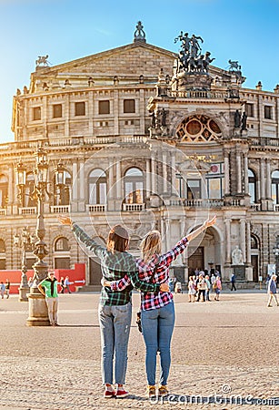 Two happy Women friends hugging and admiring view of Semper Opera Theatre in Dresden Editorial Stock Photo