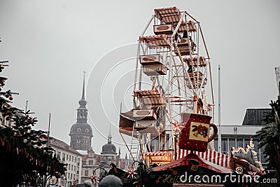 Dresden, Saxony, Germany, 10 December 2022: Christmas outdoor market stall decorations with fairy with lights, wooden ferris wheel Editorial Stock Photo