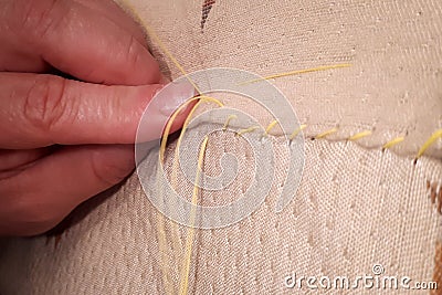Dress maker working. Woman hadn sewing clothes. Closeup sewing. Stock Photo