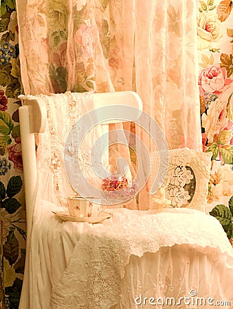 Dress, teacup and frame on white chair Stock Photo