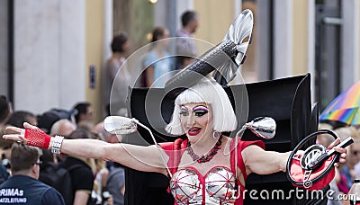 2018: A dressed up man in a crazy female car dress attending the Gay Pride parade also known as Christopher Street Day CSD, MUC Editorial Stock Photo