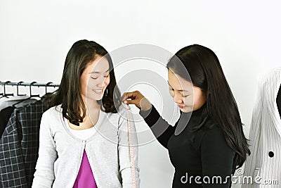 Dressmaker designer making and measure garment on customer body. Stock Photo