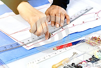 Dressmaker designer making pattern and measure garment. Stock Photo