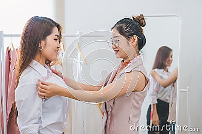 Dressmaker measuring female customer shoulder and chest in sewing atelier workshop office. Tailor and fashion designer concept. Stock Photo