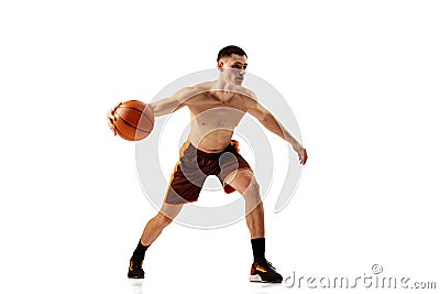 Dribbling. Dynamic footage of professional basketball player training with basketball ball isolated over white Stock Photo