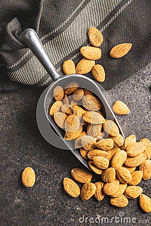 Dried almond nuts in metal scoop Stock Photo