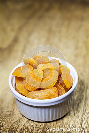 Dried apricots in a ceramic white bowl Stock Photo