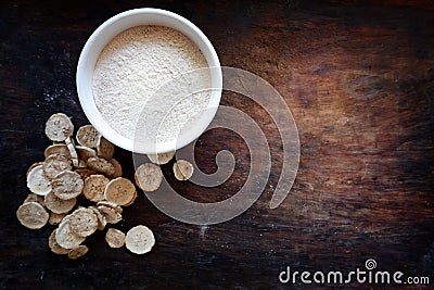 Dried banana slices With raw banana powder in a cup Raw banana powder is an ancient medicine used for gastritis treatment. Stock Photo