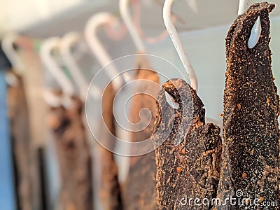 Dried beef meat biltong hanging on hooks Stock Photo