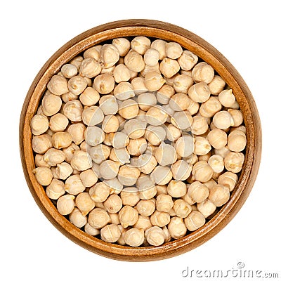 Dried chickpeas in wooden bowl over white Stock Photo