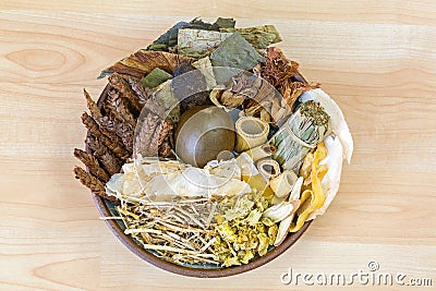 Dried Chinese mixed herbs to make cooling drinks in traditional Chinese medicine on wooden background Stock Photo