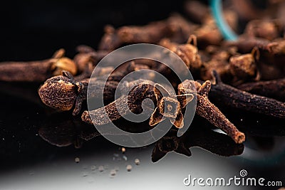 Dried clove spice next to test tube and cork Stock Photo