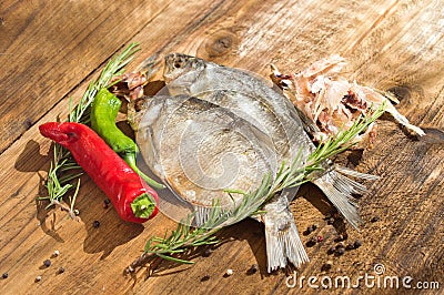 Dried fish, pepper and rosemary Stock Photo