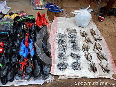 Dried fish and shoes for sale in market in Mozambique Editorial Stock Photo