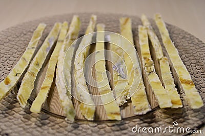 Dried fish straws on a plate on the table. Stock Photo