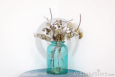 Dried flowers in the blue glass jar Stock Photo