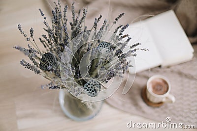 Dried flowers and a cup of cappuccino with book, spring concept. top view. flatlay Stock Photo