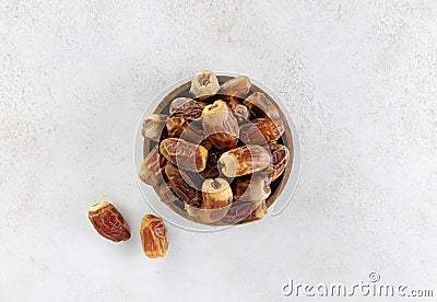 Dried fruit sagay dates in a wooden bowl on a gray background. Top view. Stock Photo