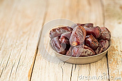 Dried fruits date palm fruits . fresh dates whole and half on wood background Stock Photo