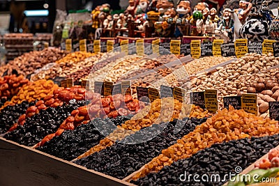 Dried fruits on the market shelves. Bright tasty delicacies. Dried apricots, raisins, prunes and nuts Stock Photo