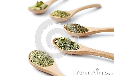 Dried Herbs on Wooden Spoons Stock Photo