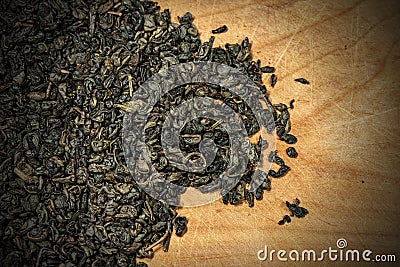 Dried leaves of green gunpowder tea on wooden background Stock Photo