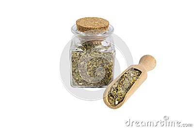 Dried leaves of yerba mate tea in wooden scoop and glass jar on isolated on white background. Stock Photo