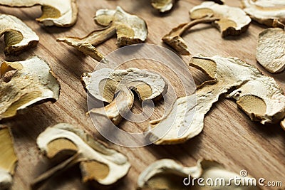 Dried mushrooms on a wooden table, non-traditional medicine and narcotic drugs Stock Photo