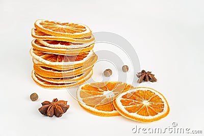 Dried orange slices stack, anise, pepper on white table background. Spices, decoration, ingredient concept. Stock Photo