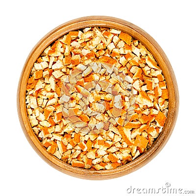Dried organic orange peel, cut into coarse pieces, in a wooden bowl Stock Photo