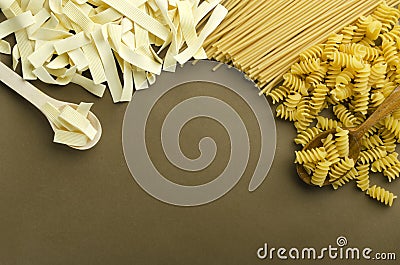 Dried pasta on the brown surface.Empty space for text Stock Photo