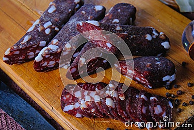 Dried pork sausages composition on a wooden background Stock Photo
