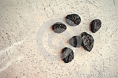 Dried prunes on a textured background Stock Photo