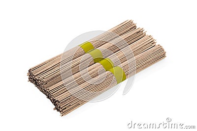 Dried raw japanese soba noodle sticks isolated on a white background. - Image Stock Photo