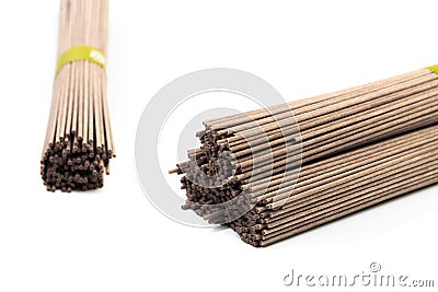 Dried raw japanese soba noodle sticks isolated on a white background. - Image Stock Photo