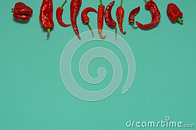 Dried red chili peppers lie on a multi-colored background Stock Photo