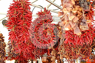 Dried red chillies hanging on a market place Stock Photo