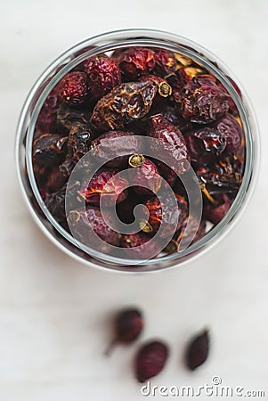 Dried rosehips in a jar on a light background, close-up Stock Photo