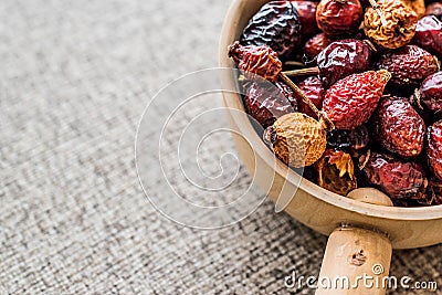 Dried Rosehips in wooden ladle / kusburnu Stock Photo