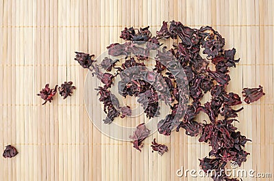 Dried Roselle flowers on wood background. Top view Stock Photo