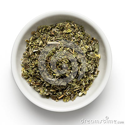 Dried rubbed sage in white ceramic bowl isolated on white from above Stock Photo